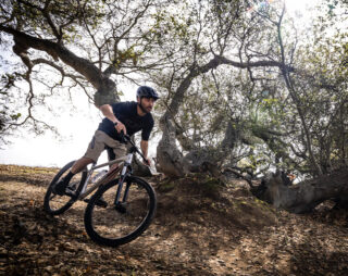 image of rider Ian climbing a hill on a Bobcat Trail 4