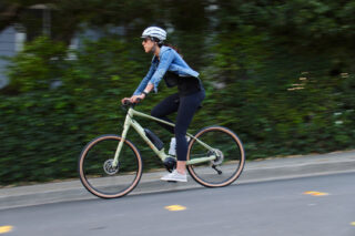 Woman riding Marin Sausalito down a hill in city